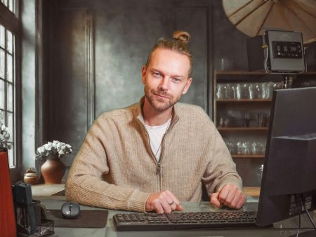 A man sitting in front of a laptop computer